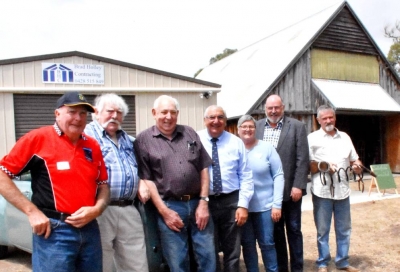 Pat Gillespie, Ian Docherty, Rex Holley, MP Thomas George, Anne Stackman, Tenterfield deputy mayor Greg Sauer and Edi Vah line up in front of the new and old Men&#039;s Sheds.